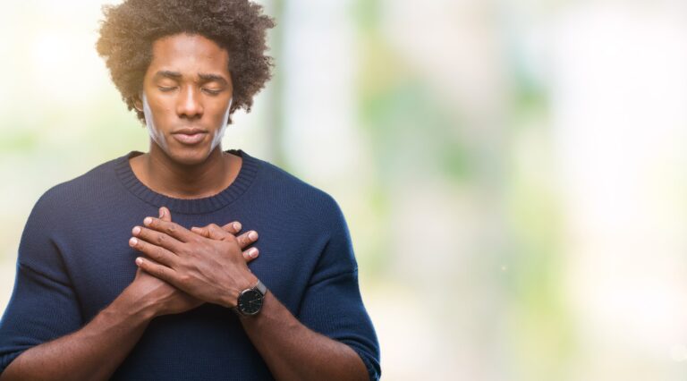 man holding chest with shortness of breath